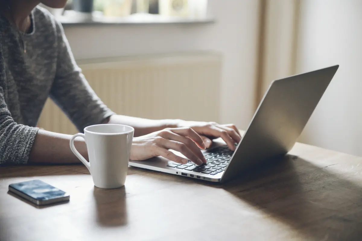 Person working on a laptop at a table